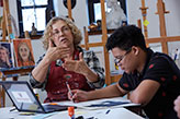 An art teacher talking to her class. Links to Gifts That Protect Your Assets