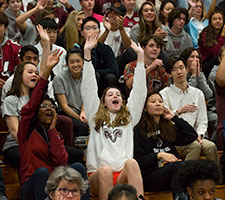Students cheering at an event. Links to Gifts from Retirement Plans